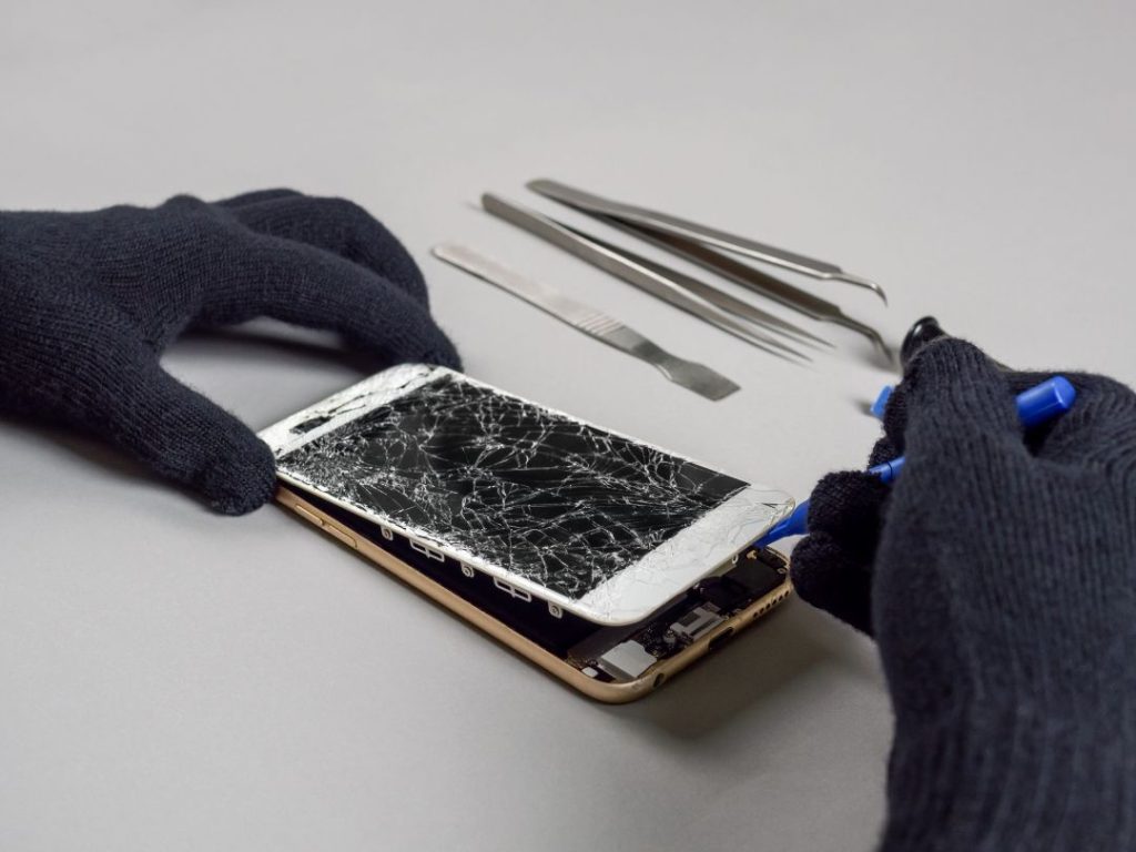 technician repairing iphone broken screen