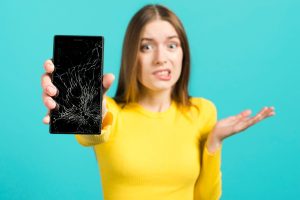 women holding crack screen phone